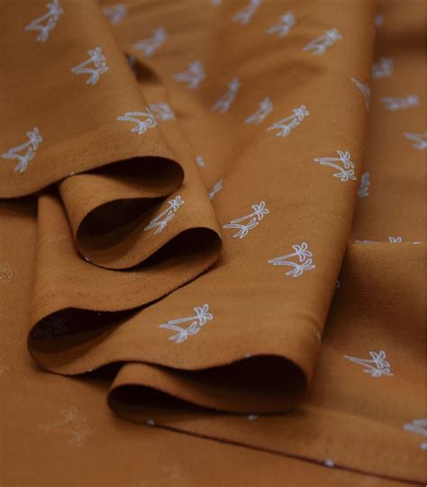 Popeline de coton brun orangé imprimée Palmito