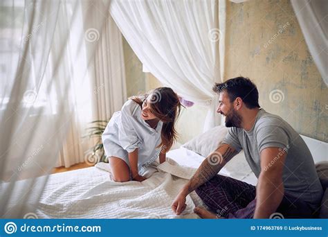 Young Beautiful Couple Laughing Early In The Morning In The Bedroom. Morning, Adults, Satisfied ...
