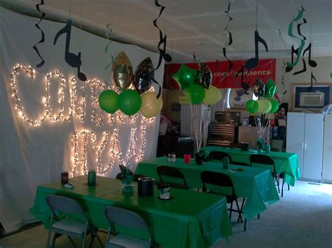 A Room Filled With Green Tables Covered In Balloons And Musical Notes