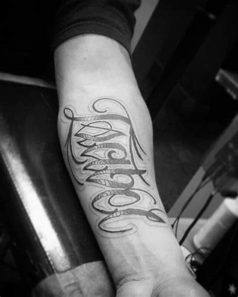 A small tattoo on your wrist or bicep is like putting on a watch versus a shirt. 40 Forearm Name Tattoos For Men - Manly Design Ideas