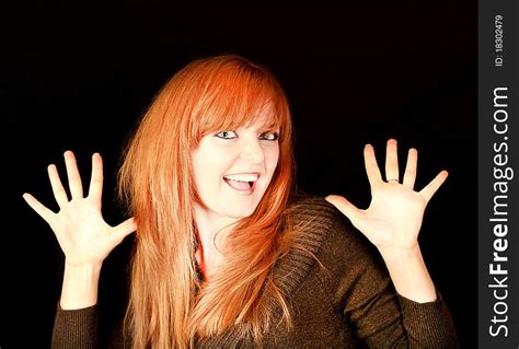 Young Red Haired Girl Smiling On A Dark Background Free Stock Images