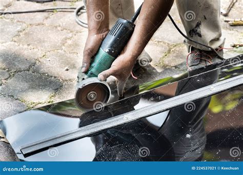 Worker Cutting Roof Polycarbonate Sheet With Cutter Tool Stock Image