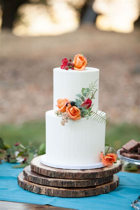 Simple White Wedding Cake With Orange And Red Flowers
