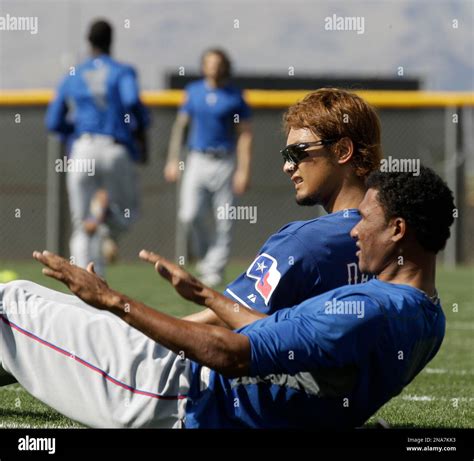 Texas Rangers Pitchers Yu Darvish Of Japan And Alexi Ogando Front Do Exercises At Baseball