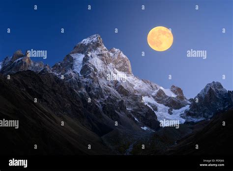 Ushba Is The Mountain Peak Of Caucasus Night Landscape With Full Moon