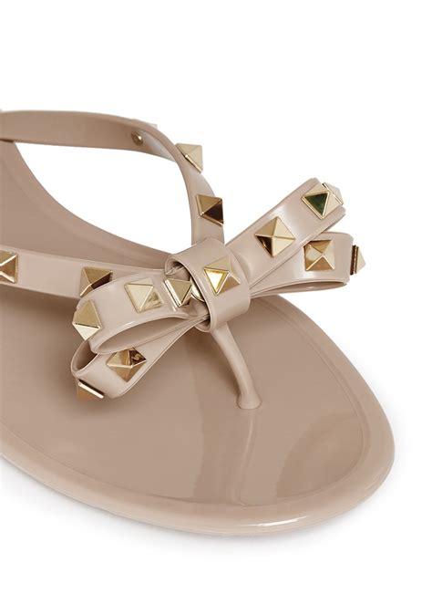 Lyst Valentino Rockstud Bow Flat Jelly Sandals In Natural