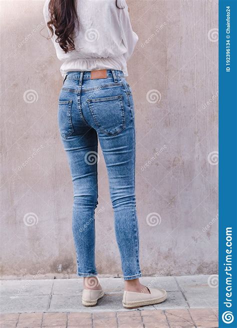 happy asia woman in bright blue skinny crop jeans sky blue jeans stock