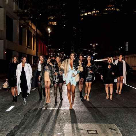 Several Women Walking Down The Street At Night