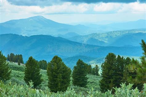 The Ridge Of Mountains Covered With Forest Is Under A Cloudy Sky Stock