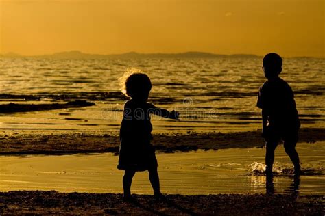 Children Playing With Fun On The Sunset Sea Beach Stock Image Image