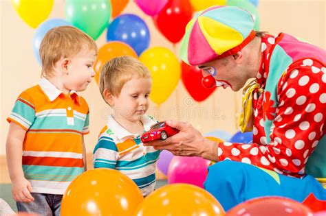 Happy Children With Clown On Birthday Party Stock Photo Image Of