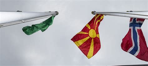 The north macedonian flag is a red field with a yellow sun. UN chief hails victory of 'political will' in historic ...