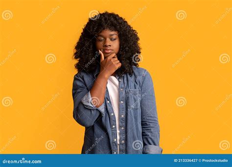 Confused Young Black Woman Thinking And Looking Aside Stock Image