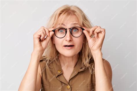 Premium Photo Portrait Of 50 Year Old Lady Squinting In Glasses