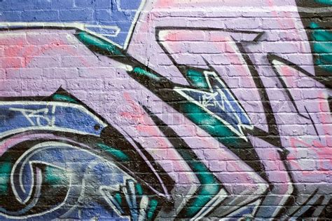 Colorful Graffiti Spray Painted On A Brick Wall Makes A