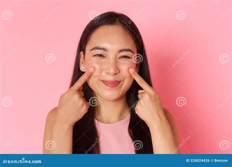 beauty fashion and lifestyle concept close up of silly and cute adorable asian girl poking