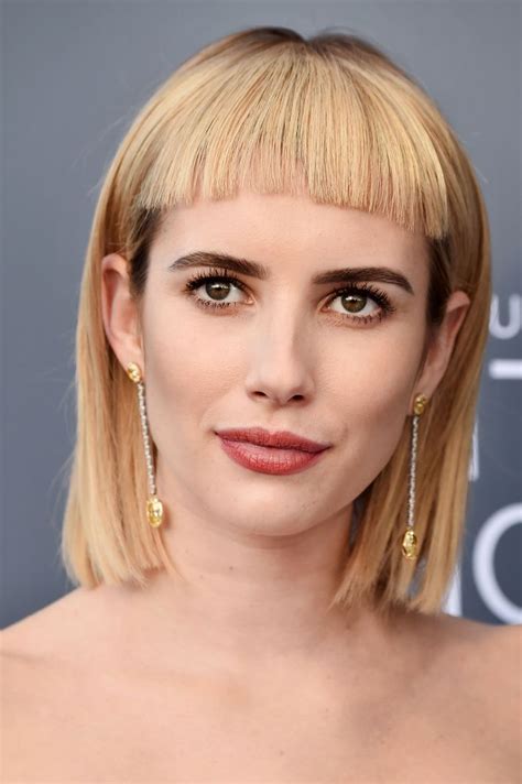 This medium length hairstyle is characterized by blonde hair being combed straight towards the direction it is facing. Emma Roberts Debuts Controversial Bangs at Critics' Choice