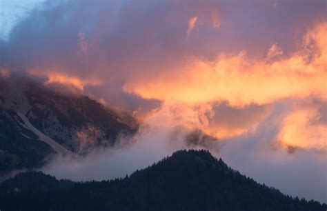 Clouds Rising Up Above Wooded Mountain Slopes During Sunset In Jesenice