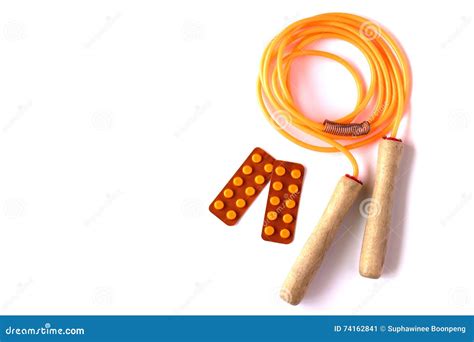 Orange Jump Rope With Blisters Of Pills On White Background Healthy