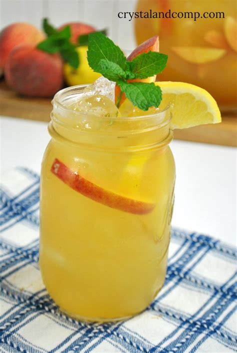 A Mason Jar Filled With Lemonade And Apple Slices
