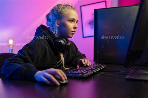 Focused Professional E Sport Gamer Girl Playing Online Video Game On Pc