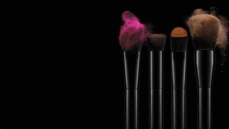 Brushes With Coloured Make Up On A Dark Background