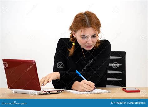 Shocked Serious Young Office Worker Woman Sitting Behind Working Desk
