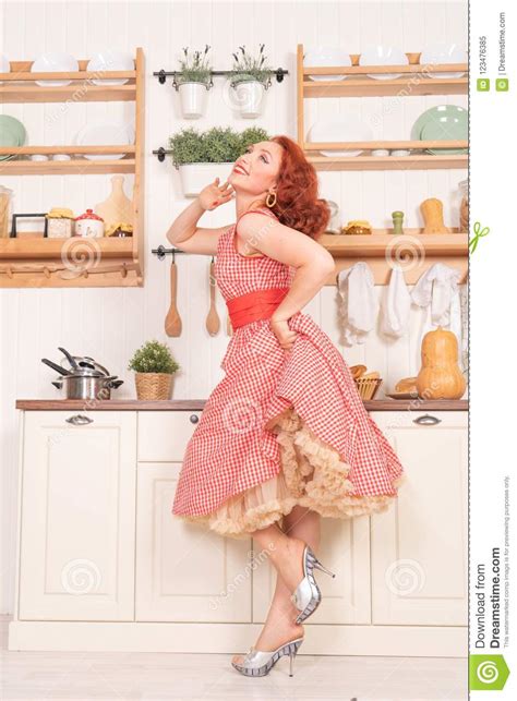 Beautiful Red Haired Pinup Smiling Happily Girl Posing In A Retro Red
