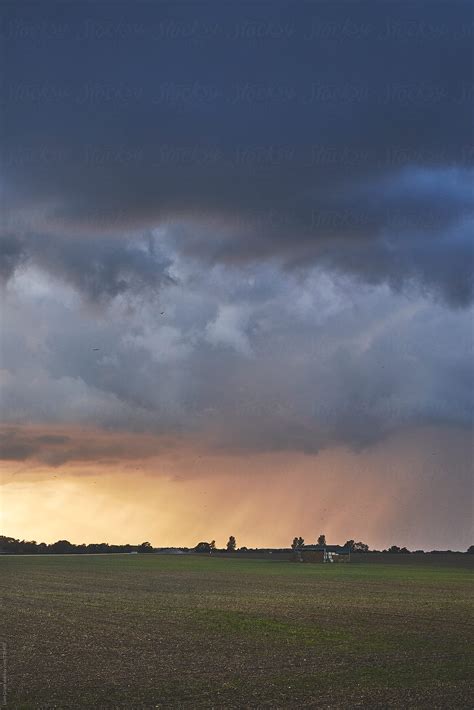 Dark Stormy Sky Over A Barn At Sunset. Norfolk, UK. by Liam Grant