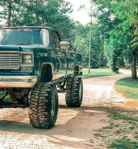 A Large Truck Parked On Top Of A Dirt Road