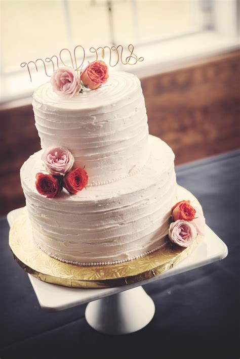 Two Tier Buttercream Wedding Cake With Pink Flowers And