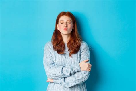 Cute Redhead Teen Girl Waiting For Kiss Pucker Lips And Close Eyes Standing In Sweater Against
