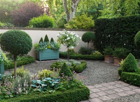 The clean symmetry of the poured concrete path is offset by the wild display of flowering plants. Front Garden Design