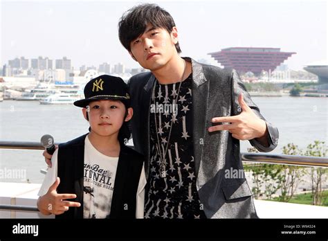 Taiwanese Singer And Actor Jay Chou Right Poses With Chinese Child