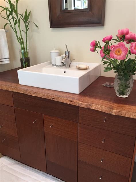 When most homeowners choose a countertop for their bathroom vanity, the focus tends to be on how it'll look and how much it'll cost. Rustic Bathroom Vanity with Live-Edge Wood Countertop and ...