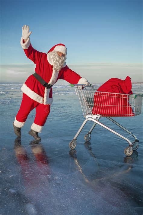 Santa Claus Carries A Shopping Cart With Ts In A Sack Stock Image