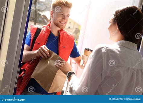 Courier Giving Order To Young Woman At Open Door Stock Image Image Of