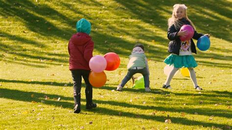 Little kids playing with balloons outdoors Stock Video Footage ...