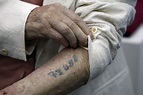 auschwitz-survivor-showing-identification-tattoo - Remembering the ...