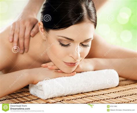 Young And Beautiful Girl Relaxing In Spa Salon Massage Therapy Over