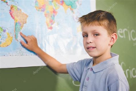 Portrait Of Schoolboy Pointing At Map In Classroom — Stock Photo