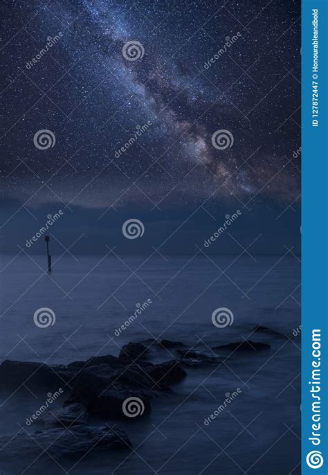 Vibrant Milky Way Composite Image Over Landscape Of Rocks In Sea Stock