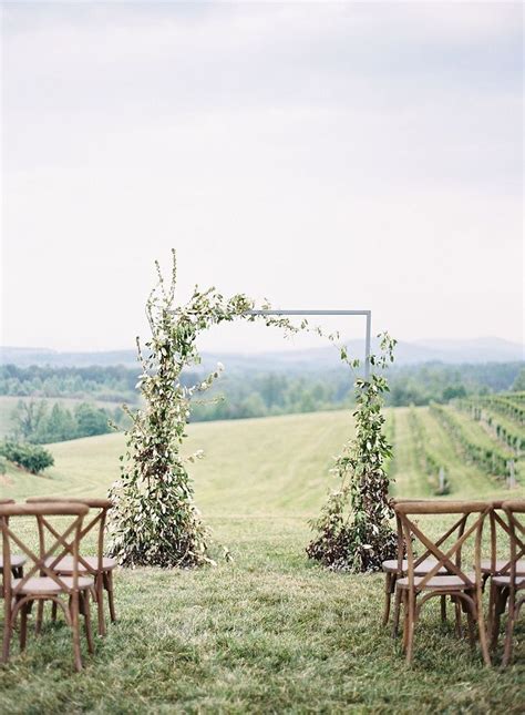 Asymmetrical Ceremony Arch With Wild Flowers And Greens Photo By