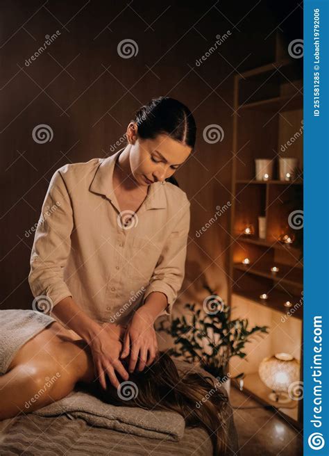 A Masseuse Gives A Head Massage To A Woman At The Spa A Professional