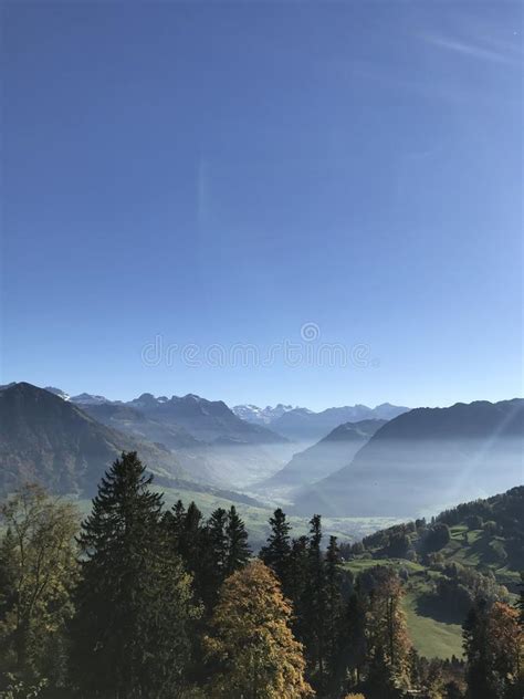 Mountain Panorama With Different Layers And Blue Sky At Buergenstock In