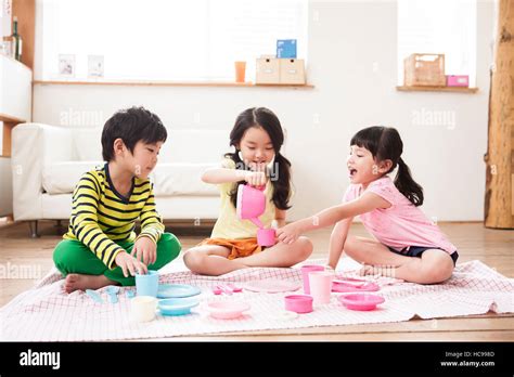 Three Smiling Children Playing House In Living Room Stock Photo Alamy