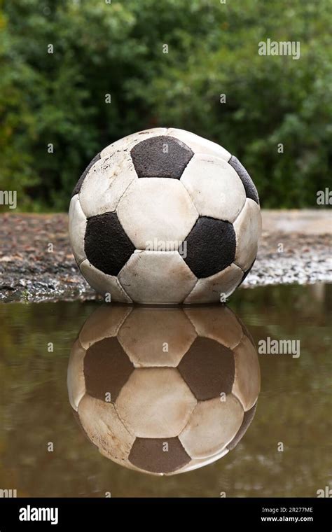 Dirty Soccer Ball In Muddy Puddle Outdoors Stock Photo Alamy