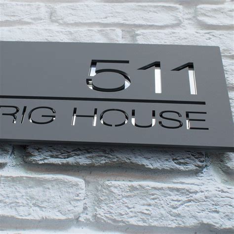 A Sign That Reads 511 Big House On Its Side Wall Next To A Brick Wall