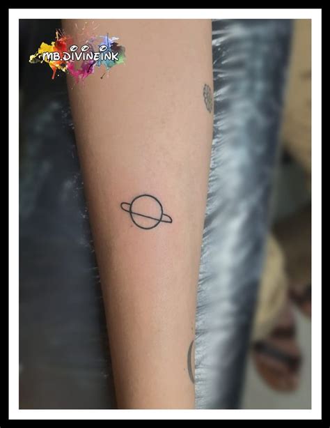 A Small Saturn Tattoo On The Arm