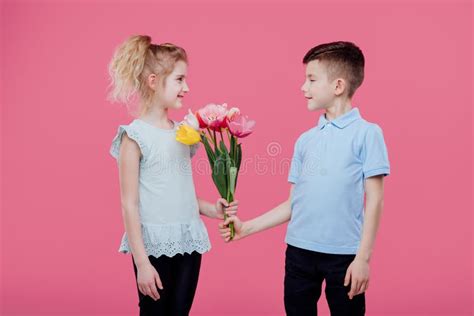 Boy Giving Flowers To Girl Pink Background Stock Image Image Of